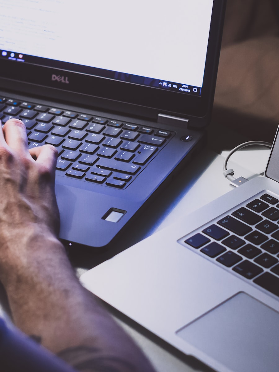 Hands typing on a laptop