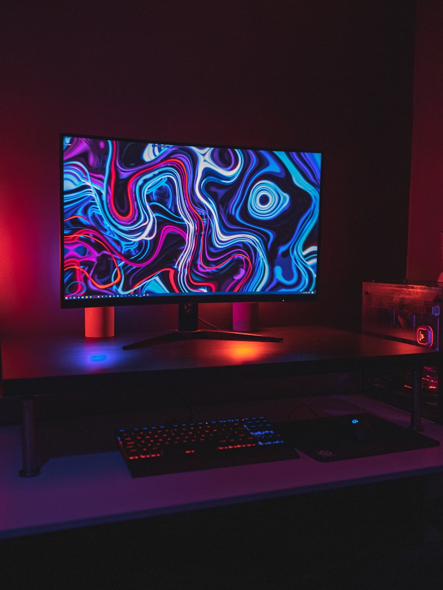 A gaming desk lit in purple and blue